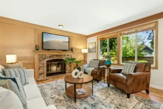 Inviting family room with a fireplace and a wall of widows allowing for lots of natural light.