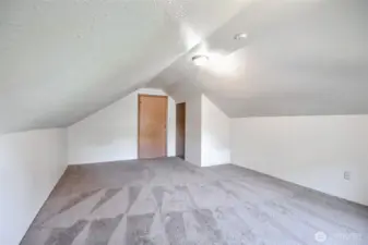 Spacious bedroom at the top of the stairs with flexible layout