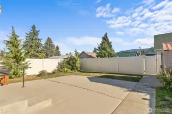 Easy maintenance back yard with large patio and underground sprinkler system.  Tall privacy vinyl fence with gate to the alley.