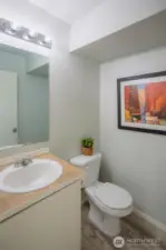 Powder Room on the Main Floor with New Waterproof Vinyl Flooring.