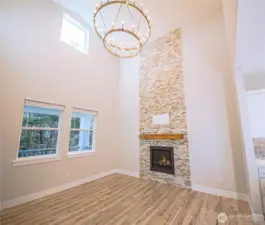 2-Story ceiling in the living room. *Previous build pictured with floor to ceiling stone is an upgrade you can  include.