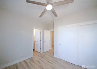 Ceiling fan, large closet and attached bath in the main floor primary. *Previous build