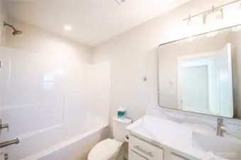 Attached bath on guest room 2. Please note you can choose step-in showers or a bathtub/shower combo.   *Previous build