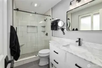 Primary Ensuite Bathroom BRAND NEW!!!!! Gorgeous remodeled and updated bathroom, new lighting, quartz vanity, tile floors, tile shower w/bench, shampoo niche and shelves plus new plumbing fixtures!
