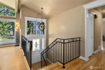 Front Entry and stairwell with iron railings and REAL hardwood floors, plus the Lake View!