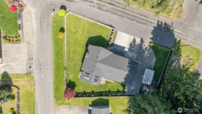 Only one neighboring property! Large shy 1/4 acre corner lot, fully fenced and look at all your parking areas!!!! Paved area out front is part of this property!