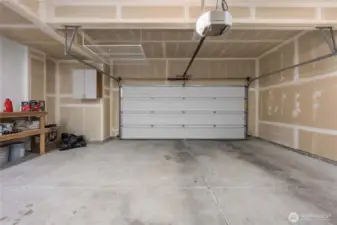 Rare expanded 2 car garage with workbench area. Storage rack does not convey.