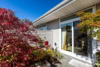 LARGE SLIDING DOOR OFF DINING AREA ACCESSES PRIVATE PATIO WITH PLENTY OF ROOM TO ENTERTAIN
