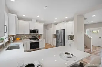 Chef's kitchen with gas range, coffee bar, ample kitchen storage and counter space.