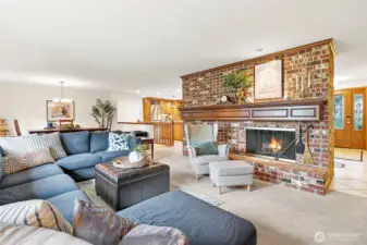 Stunning floor-to-ceiling brick wood burning fireplace creating a warm and inviting focal point.  The carpet was  replaced in 2023.