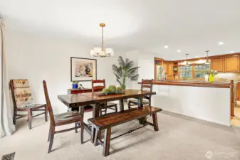 The formal dining room opens to the kitchen and living room, creating a seamless flow for entertaining, while expansive windows frame captivating views of the lake to be enjoyed from every gathering.