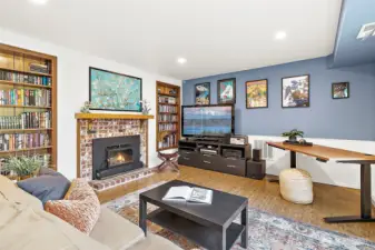 This inviting basement MIL suite features warm bamboo flooring and offers a comfortable living room, eat-in area, and cozy fireplace. Large windows fill the space with natural light and frame views of the surrounding greenery.