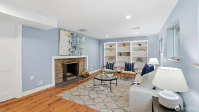 Large lower living room TV hook up behind art over the fireplace