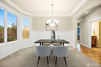 Let's bring back more diner parties with this elegant formal dining room. The recessed ceiling and wainscoting paneling carry on the craftsman architectural vibes of the home.