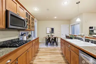 Galley style kitchen with open concept to view the whole living space. Looking out from pantry & fridge end toward the dining space.