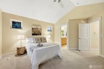 Entrance to the primary suite with en-suite bathroom right around corner from doorway.