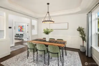 Dining room features a tray ceiling with integrated cove lighting