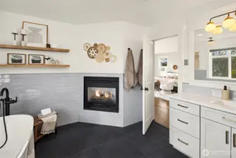 Primary bath with gas fireplace + heated floors