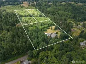 19.88 acres with home, shop, and beautiful landscaping. (Boundary lines are just for visual purposes only)