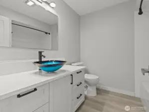 Centrally located is the gorgeous bathroom. Can we talk about that stunning vessel sink!?