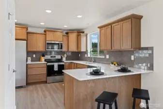 A chef's kitchen with breakfast bar peninsula.