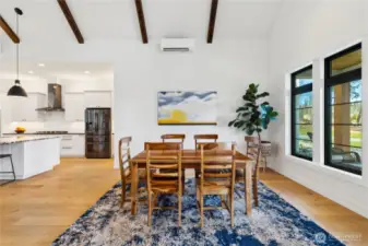 Formal dining room with views to the front and back of the home. Lots of light and vaulted ceilings.