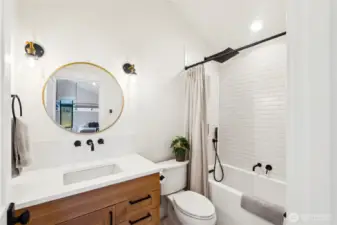 Full bathroom off the bonus room. It offers, tile floors, floating vanity, quality lighting and hardware, tiled shower surround and rain head shower head.