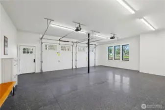 Dreamy garage is completely finish sheetrocked and painted with epoxy floors.   Streams of light, plus great lighting. There's room for workbench or workout equipment plus vehicles. This is your space, do what you want with it!