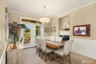 The spacious yet intimate dining room is enhanced by the two-sided fireplace shared with the living room. French doors open directly to the patio and deck, creating a seamless connection to the beautiful outdoor views.