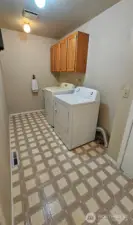 Large laundry room with storage cabinet and sink basin