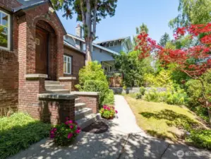 Entry to 1853 23rd Ave E. This stately brick Tudor is just minutes from top-rated schools, parks, UW, light rail & the Arboretum.