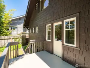 Door from back room on the main level goes to a deck. Under the deck is a door to the lower level.