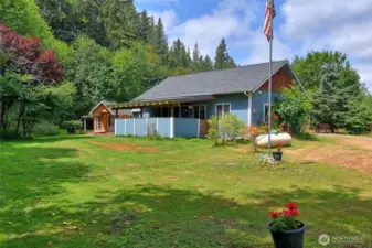 Looking at the back of the home covered deck of kitchen