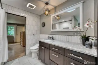 Fully updated primary bath with radiant floor heating and attached walk-in closet