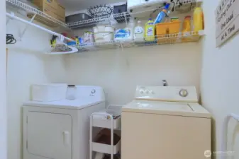 Laundry room off the hallway with plenty of storage