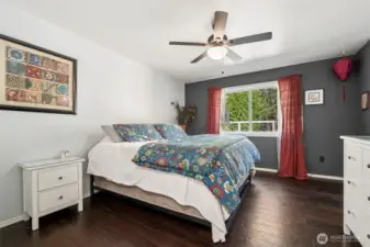 The primary bedroom has french doors and plenty of space. That is a king size bed.