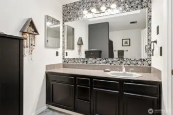 Primary bathroom with fun tile backsplash! This room has a tub shower combo