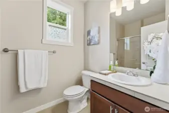The main-floor 3/4 bath sits just steps from the main floor bedroom, offering an operable window for fresh air and a beautifully clean, bright space