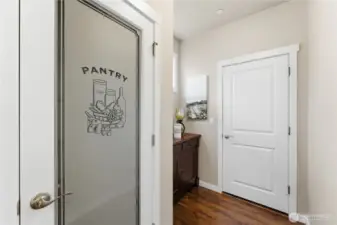 Close-up of the walk-in pantry and the door to the garage, highlighting this highly practical and efficient kitchen layout