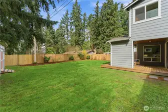 A side perspective of the covered patio, with a gentle peek at the spacious garden shed just off to the left