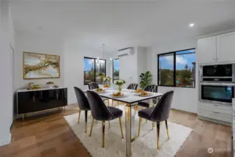 Dining room is open to the kitchen. The attention to detail really shines through with the unique light fixtures that are sure to be talking points while you entertain. [Photo is virtually staged.]