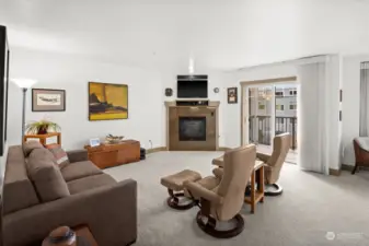 Open, light filled living area with gas fire place