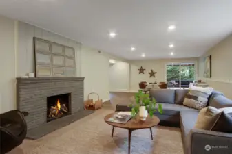 Lower level rec room with wood burning fireplace and hearth.