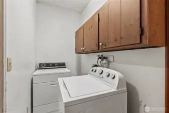 Laundry is thoughtfully tucked in at the primary end of the home.
