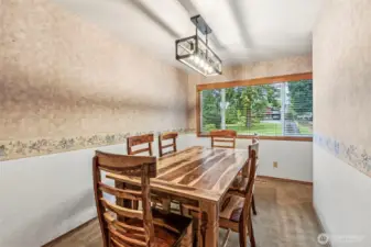 Formal dining room thoughtfully placed off kitchen in close proximity to living room. New fixtures and large window for natural light.