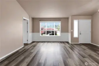 View of front door from kitchen area. To the left is an office (or bedroom?) with gas fireplace