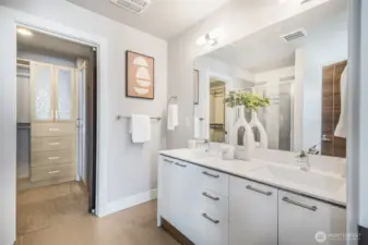 Primary bathroom includes dual-sink vanity and generous storage, blending convenience with thoughtful design