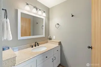 Updated primary bathroom with tile floors and updated vanity