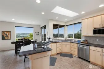Beautiful granite counters, solid wood cabinets, high-end SS appliances, and so much natural light from large windows and the skylight.