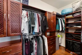 Classy solid-wood built in cabinetry in the walk-in closet keeps everything organized.